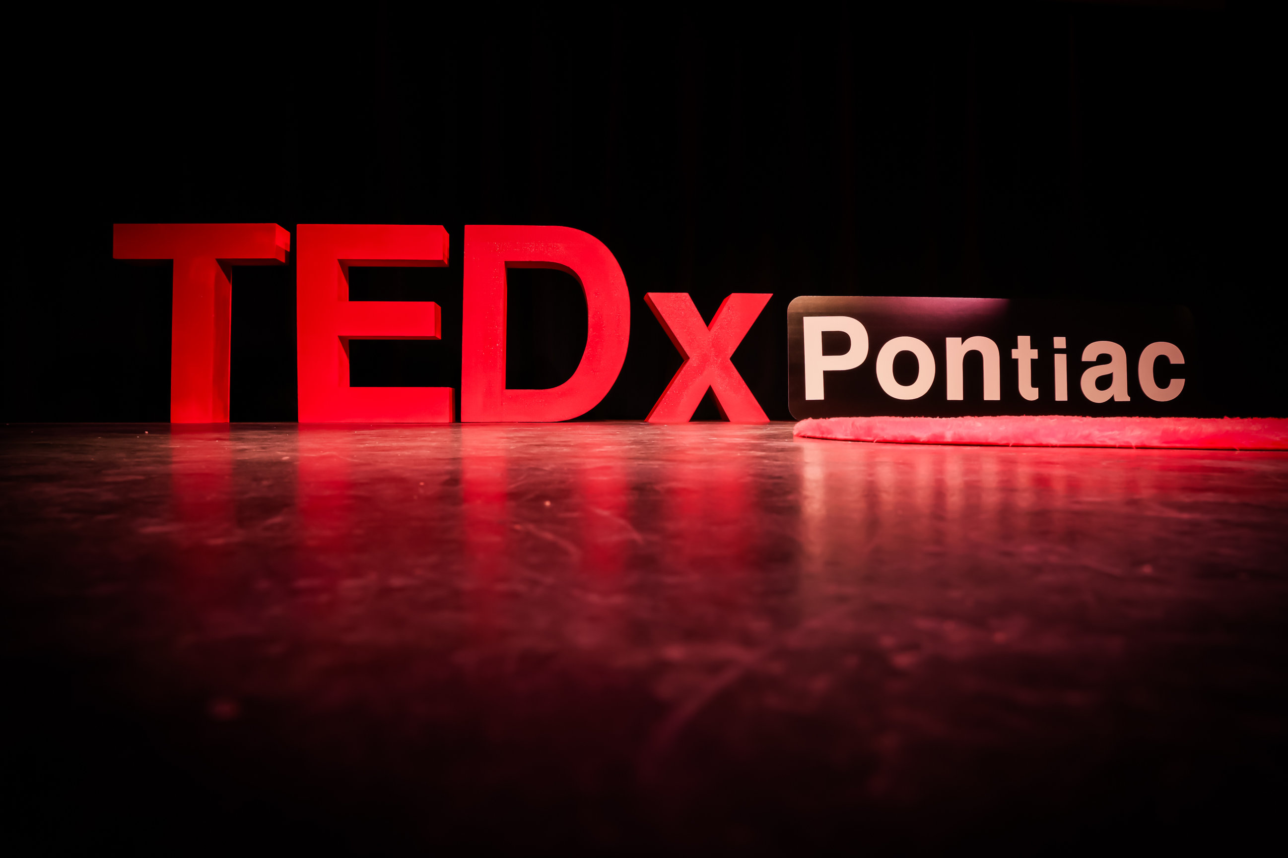 TEDxPontiac stage signage